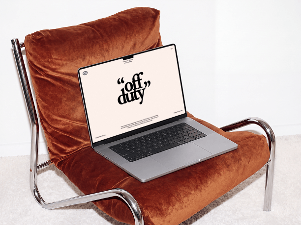 macbook mockup on a metal frame chair