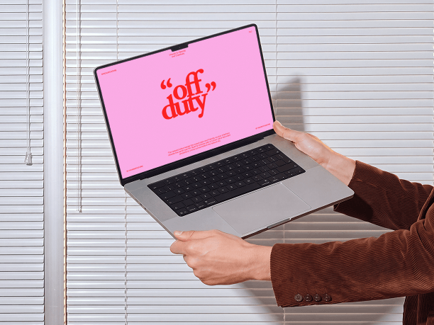 macbook mockup held by window blinds