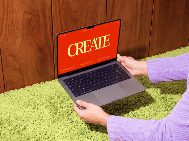 macbook mockup held above a carpet