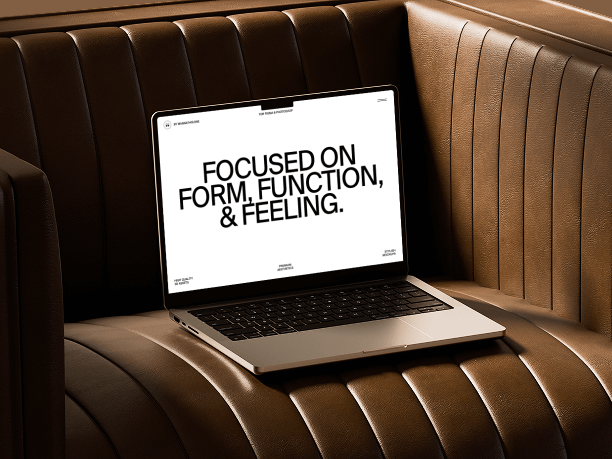 macbook mockup on cognac leather sofa