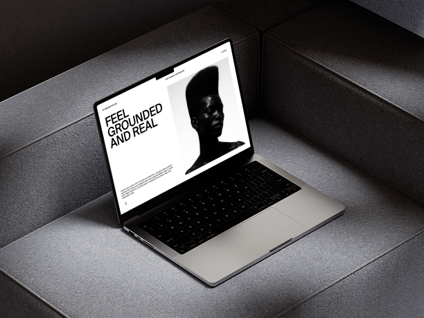macbook mockup on soft grey couch