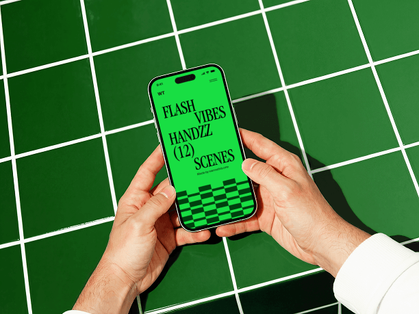 hands holding iphone on graphic surface scene