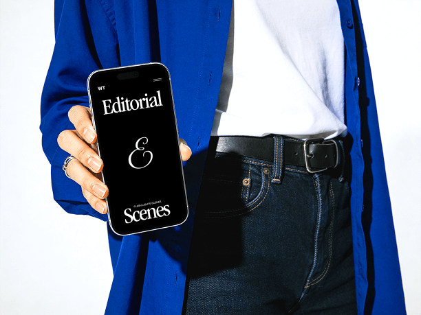 standing hand holding iphone editorial scene