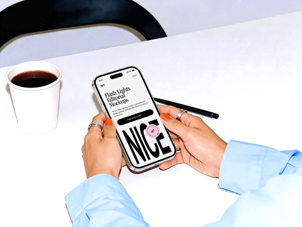 hands holding iphone on clean desk setup