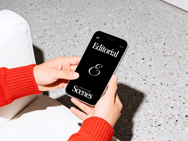hands holding iphone in modern lounge scene