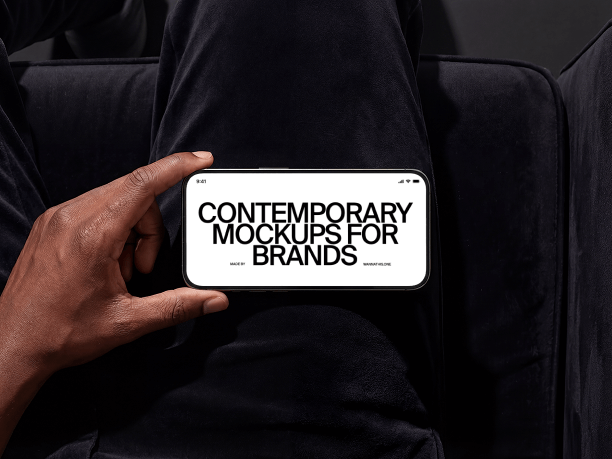 horizontal iphone mockup in hand on sofa